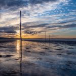 Pilgrims' Way across the salt marsh and mudflats to the Holy Island of Lindisfarne. Photographed at dusk