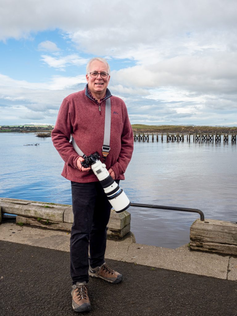 Ivor Rackham holding his OM-1 Mark II and the 150-400 F4.5 lens