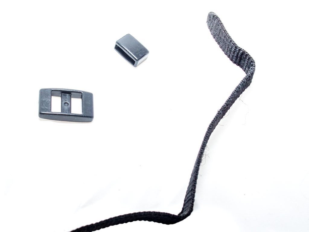 1. Take the strap off the camera. This image shows the strap end, the band keeper and the top side of the buckle.