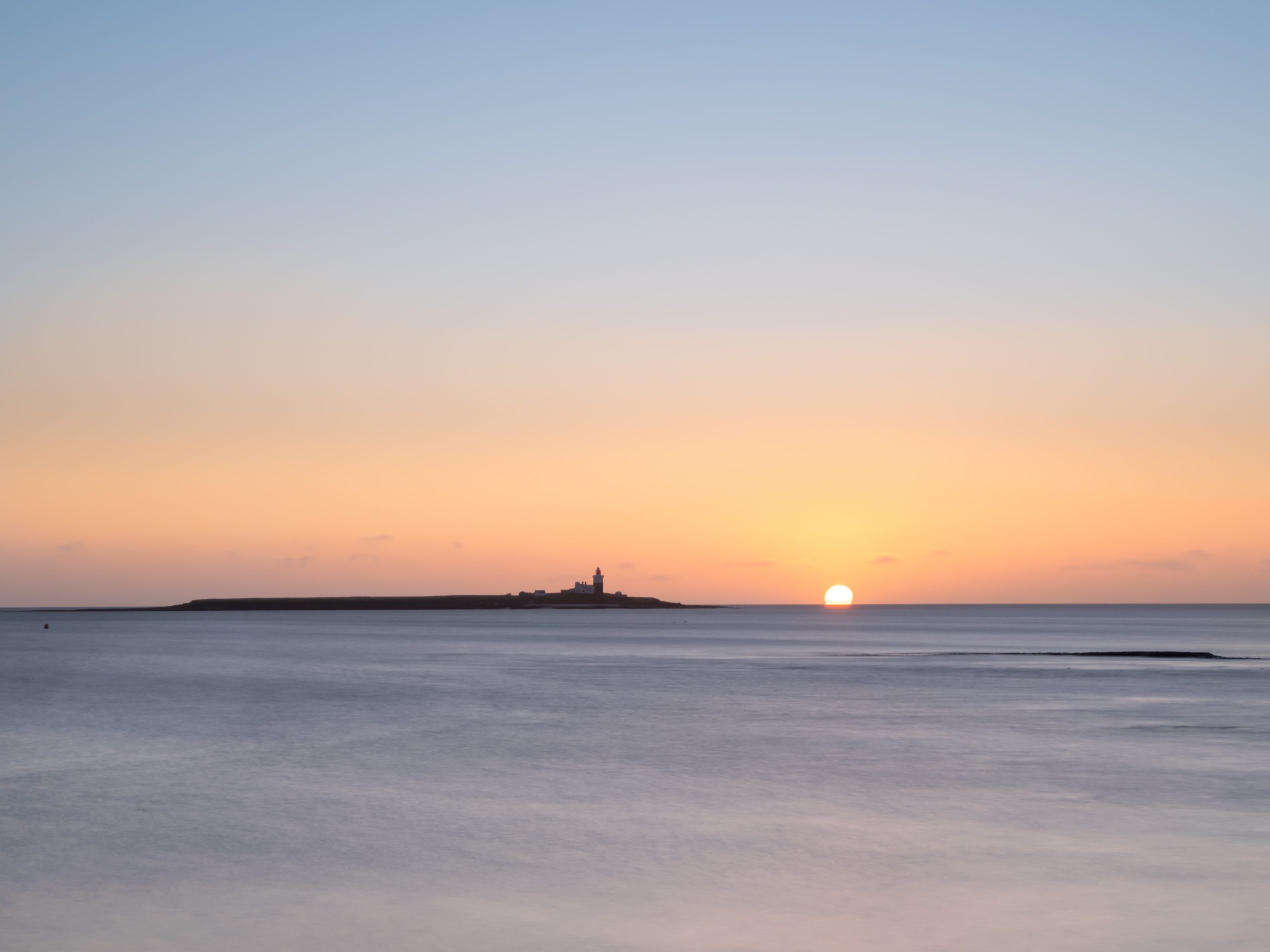 Coquet Island with the sun rising over the sea