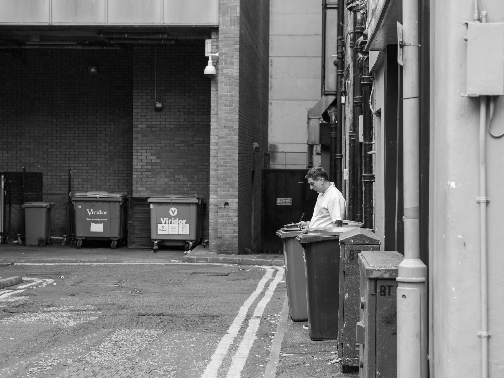 An employee steps out from the back of a kitchen for a break.