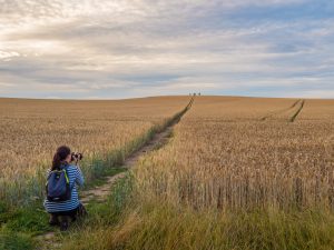Woman taking a photograph on a photography training course with Ivor Rackham
