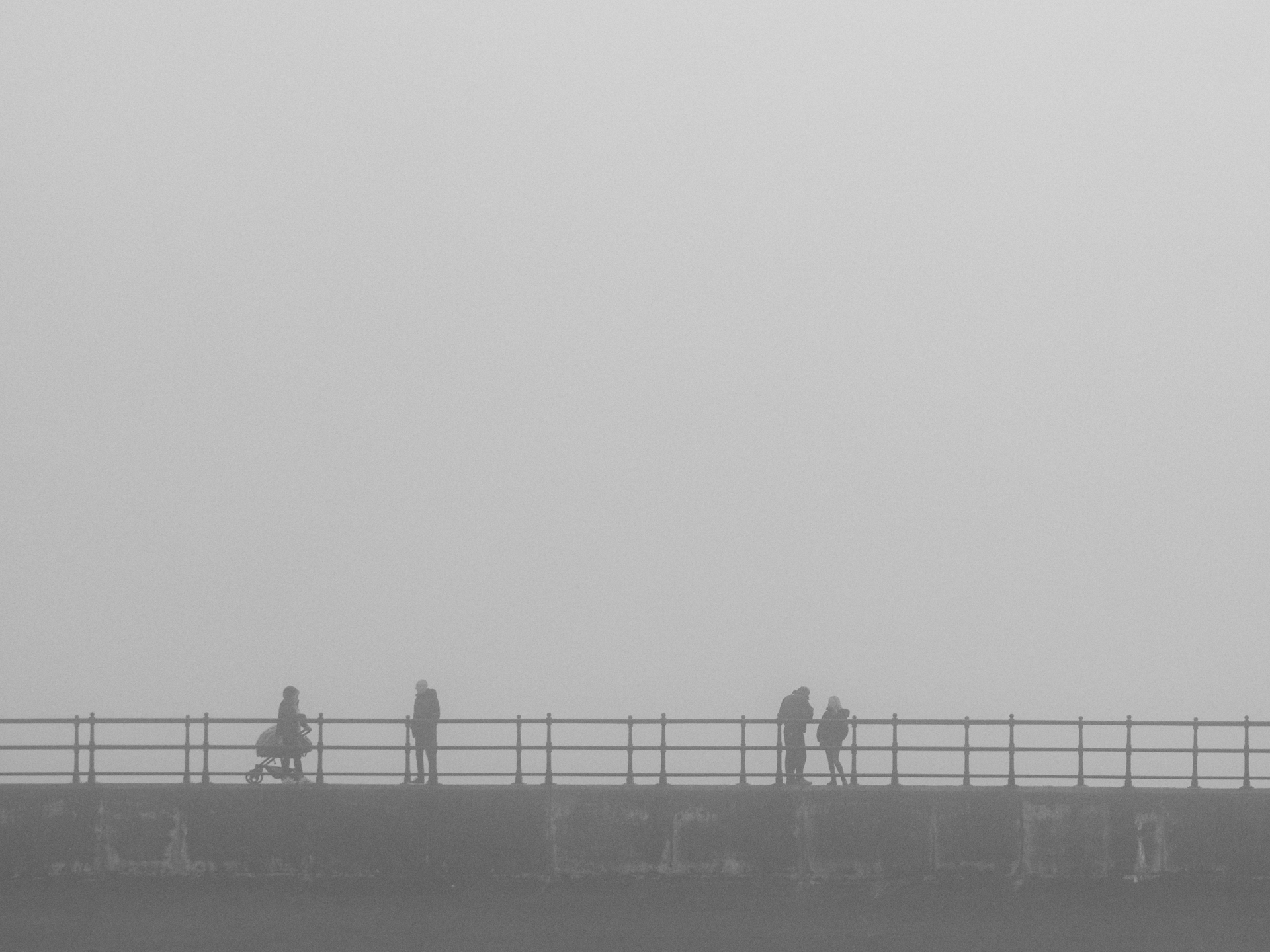 people passing in the mist