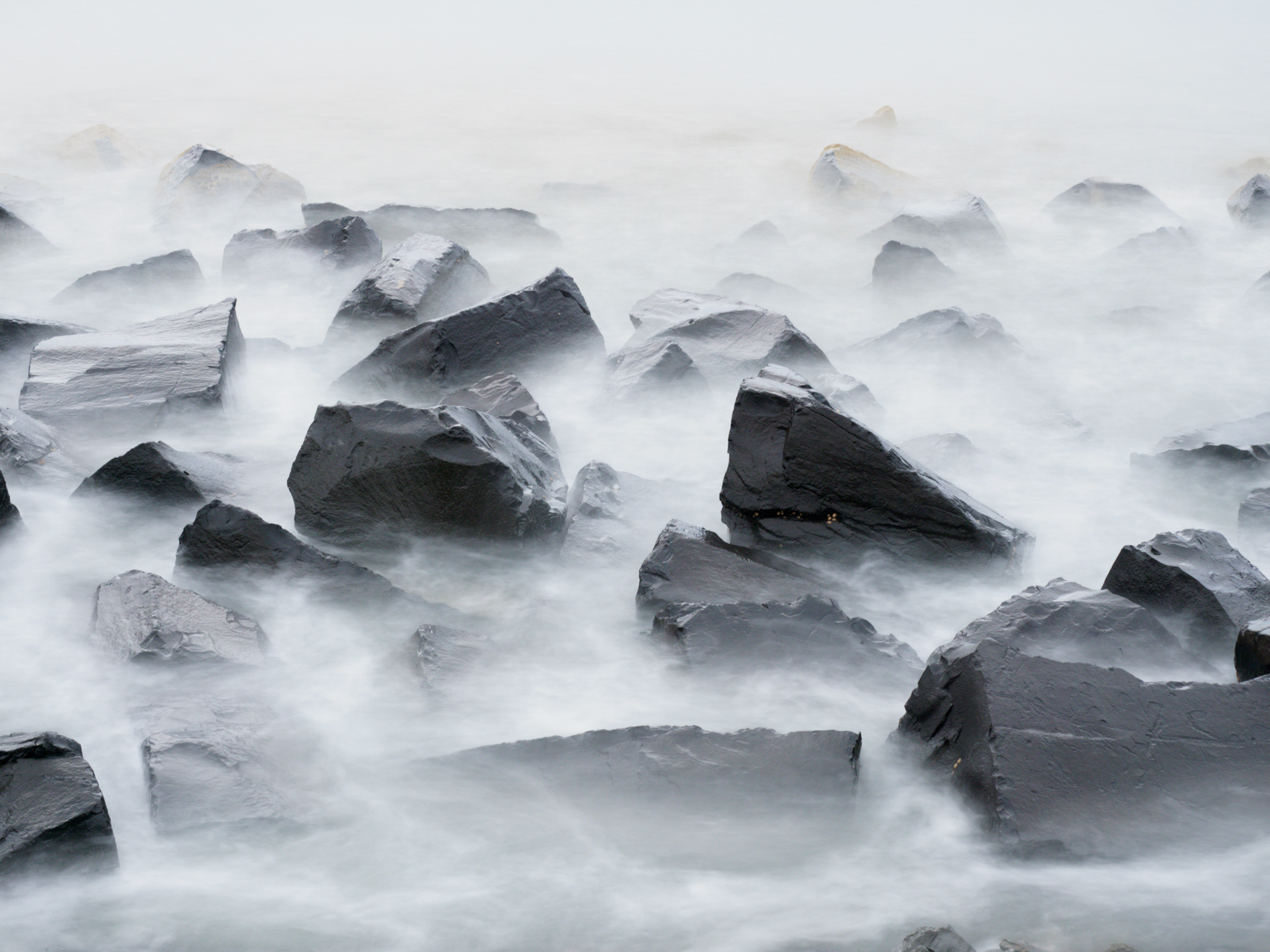A long exposure of water around rocks. GCSE