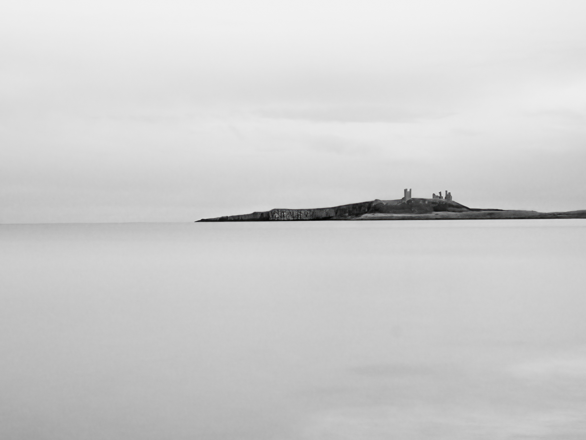 A long exposure in black and white of a headland. GCSE