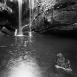A black and white photograph of a waterfall