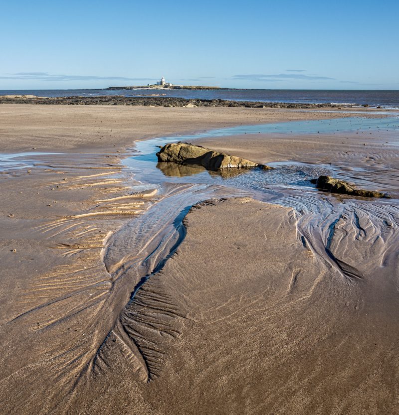 Landscape panorama picture of the beack and Coquet Island