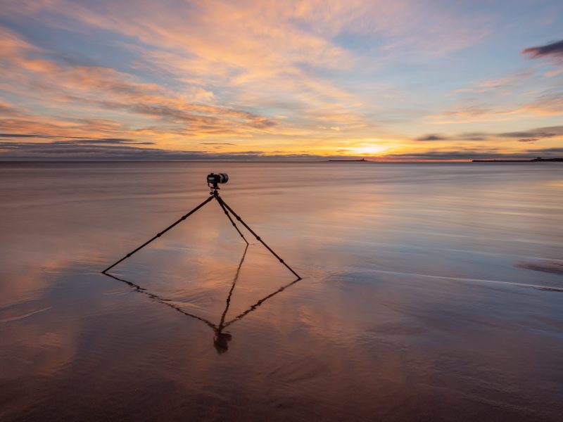 OM System camera on the beach.