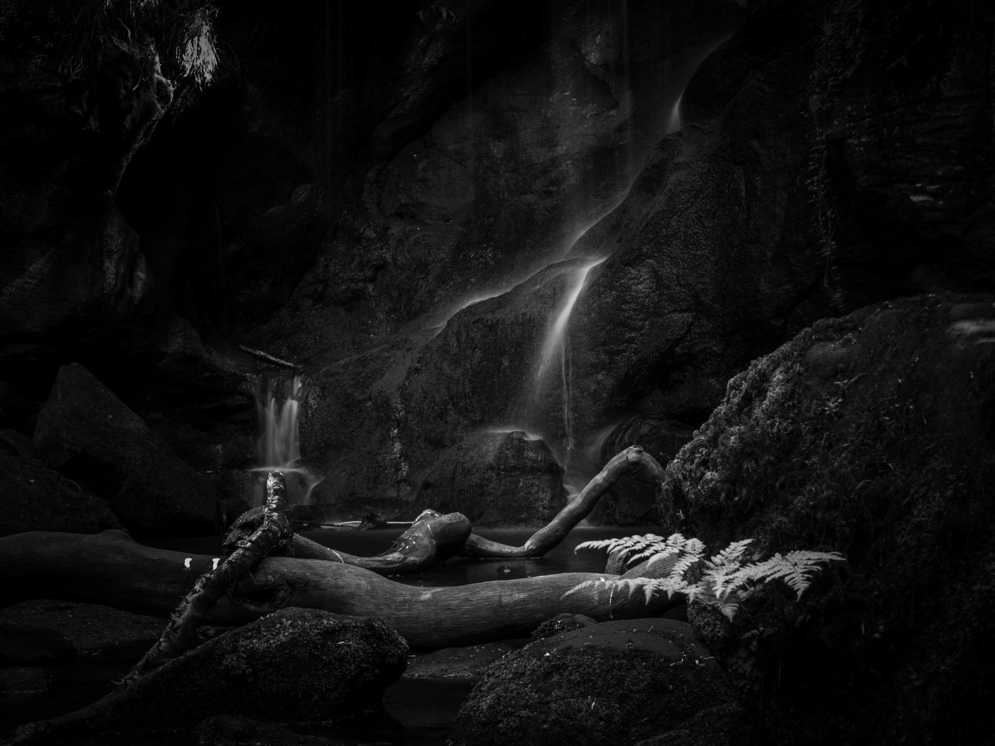 A black and white photo of a waterfall