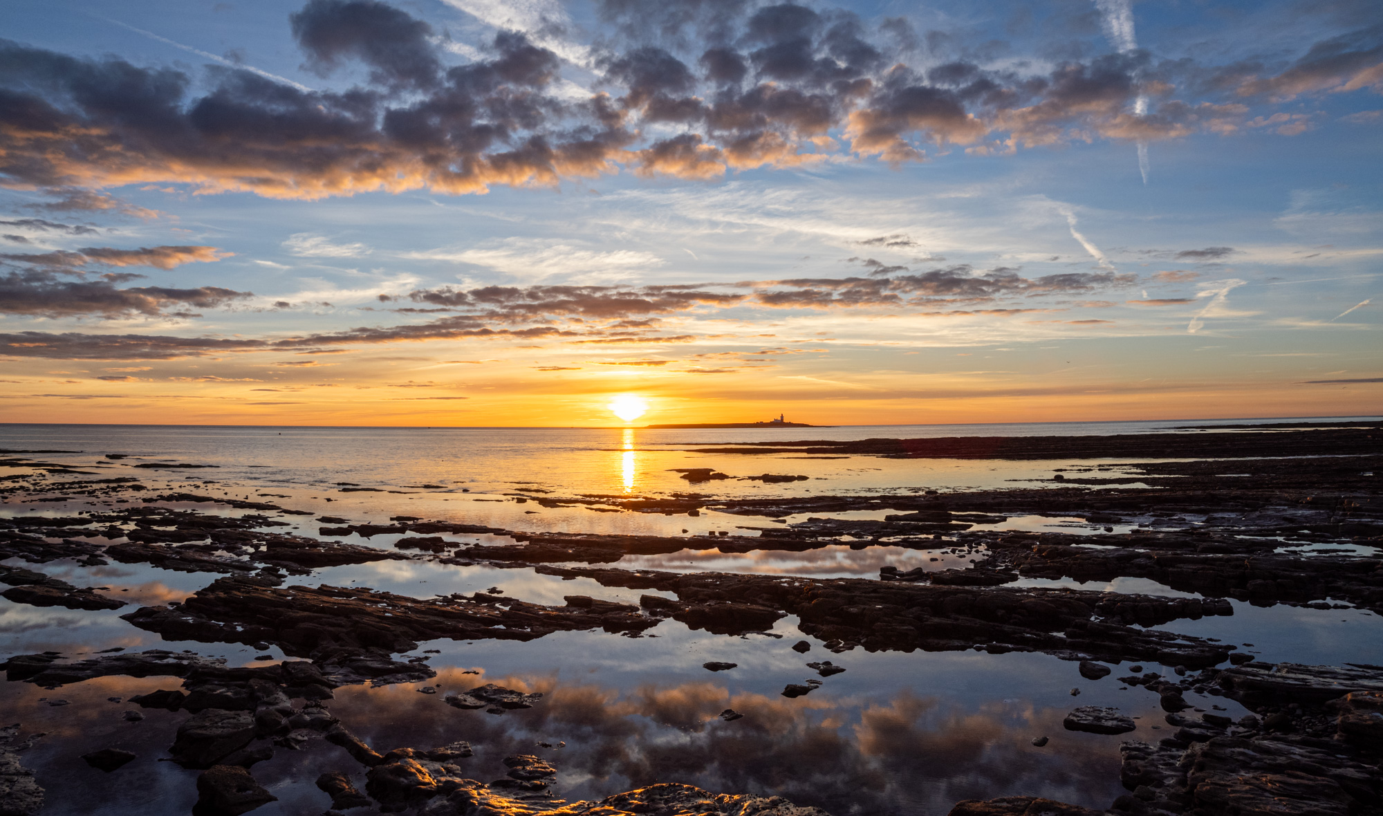 The sun rising by coquet island over the seak abd ricky foreshore.