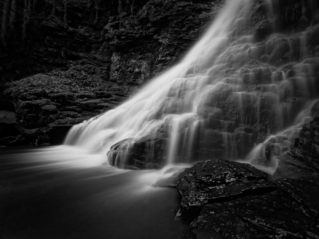 A long exposure black and white photograph of a waterfall
