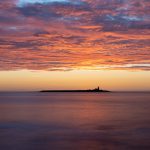An artisan photographer will explore settings and compositions such as this pre-dawn image of Coquet Island. The clouds in the sky are lit by the sun that is not yet above the horizon.